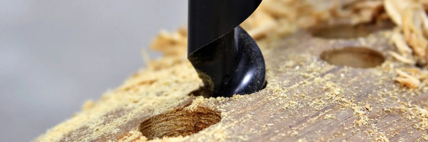 WoodOwl auger bit drilling a clean hole through lumber