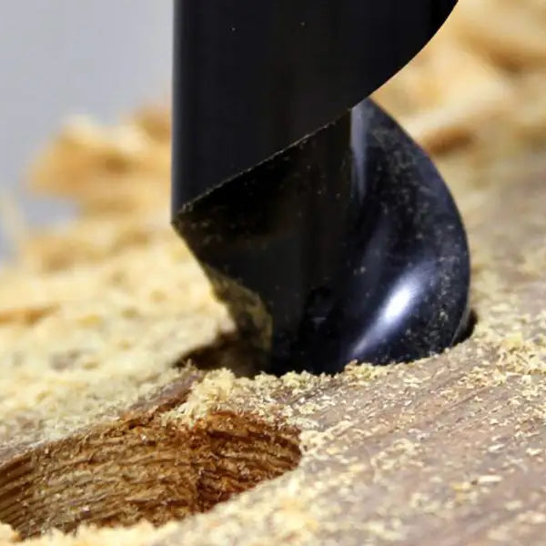 WoodOwl auger bit drilling a clean hole through lumber