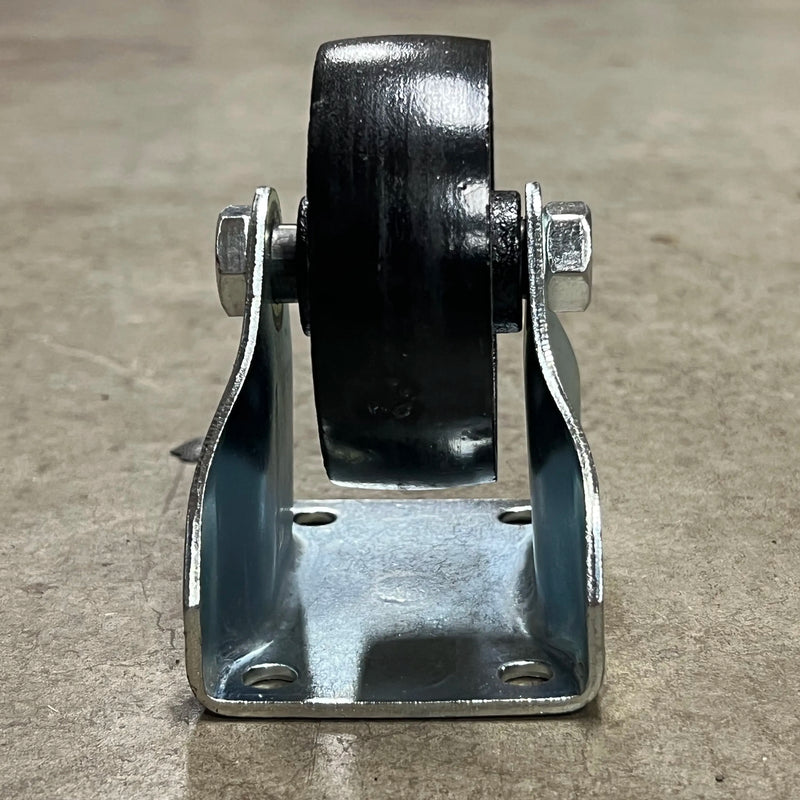 Side profile of the Steelex D4176 fixed caster showing the heavy steel support bracket and cast iron wheel.